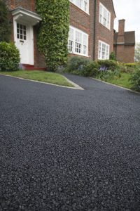 An asphalt driveway that may need repairs.